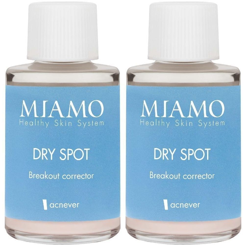Due flaconi con tappi bianchi ed etichette blu. L'etichetta riporta "MIAMO Healthy Skin System DRY SPOT Breakout corrector".