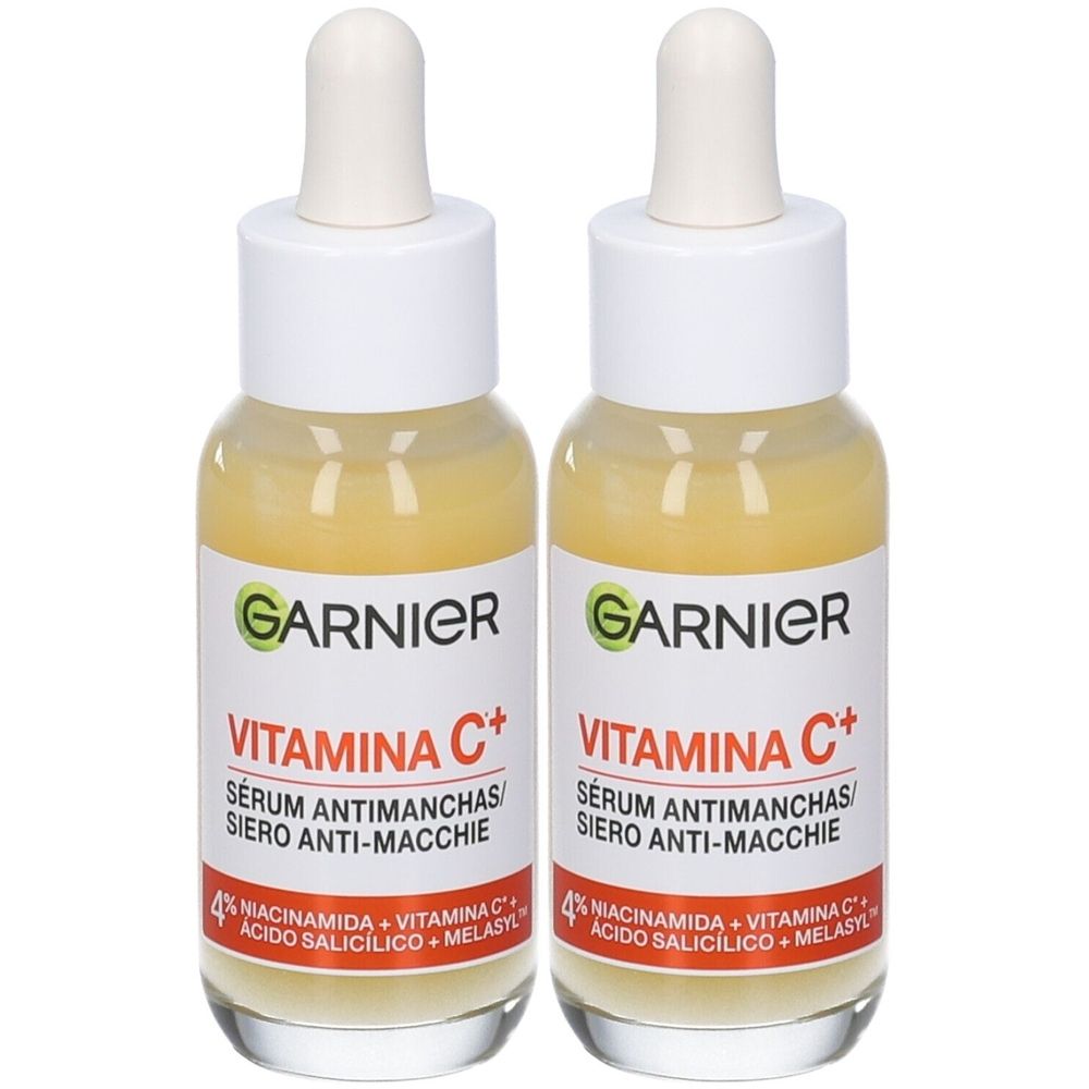 Due flaconi di siero. Scritta: Garnier, Vitamina C+, siero antimacchie. Con contagocce e tappo bianco.