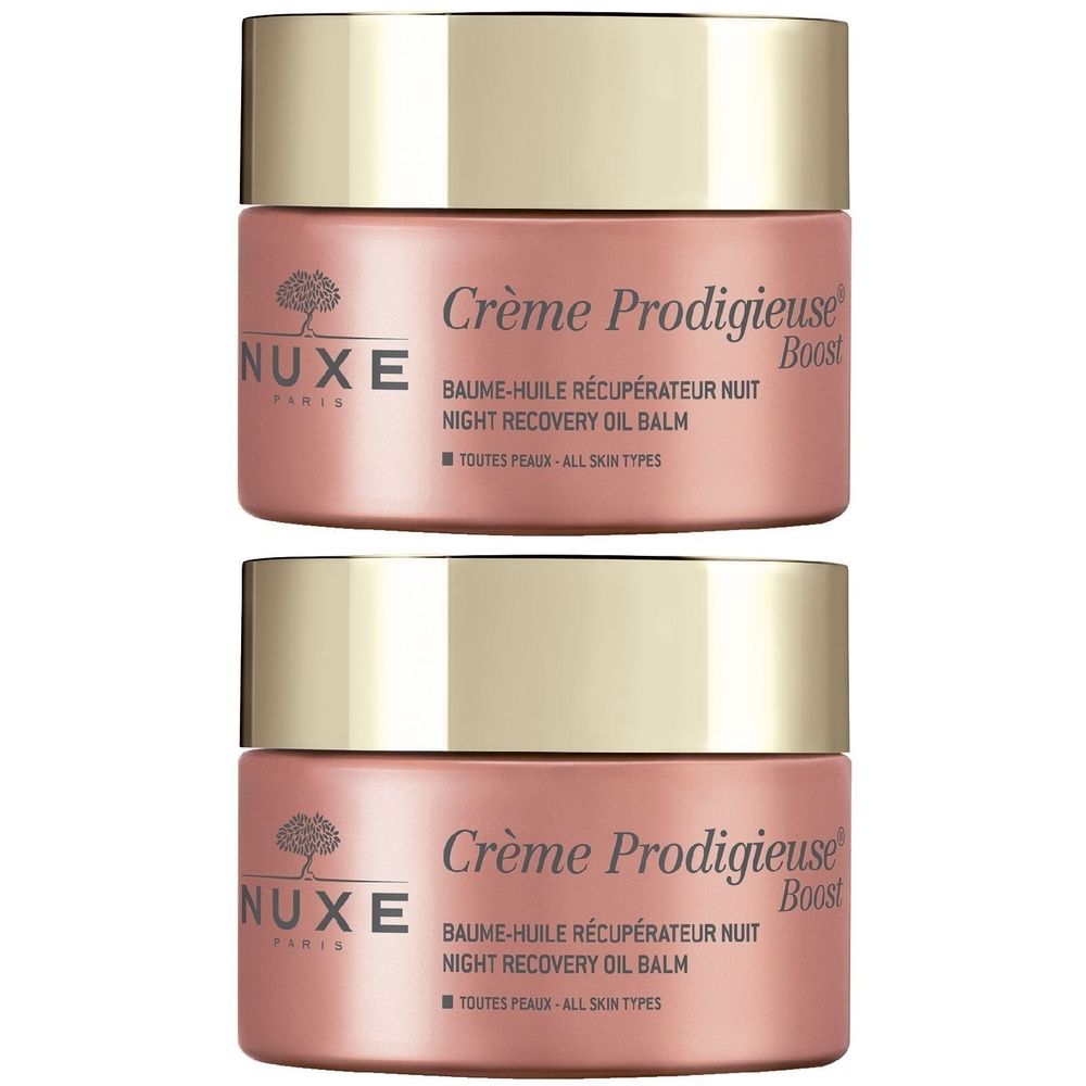 Due vasetti Nuxe Crème Prodigieuse Boost. Vasetti rosa con coperchi dorati. Scritta: Baume-Huile Récupérateur Nuit, Night Recovery Oil Balm.