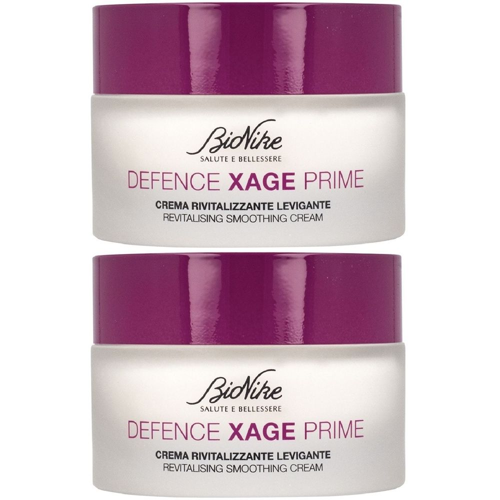 Due vasetti di crema con coperchi viola. Scritta: BioNike, Defence Xage Prime, Crema Rivitalizzante Levigante, Revitalising Smoothing Cream.