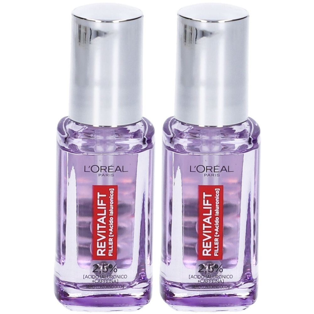 Due flaconi L'Oréal Paris Revitalift Filler. Liquido viola in bottiglie di vetro con tappi argentati. Etichette rosse con testo.