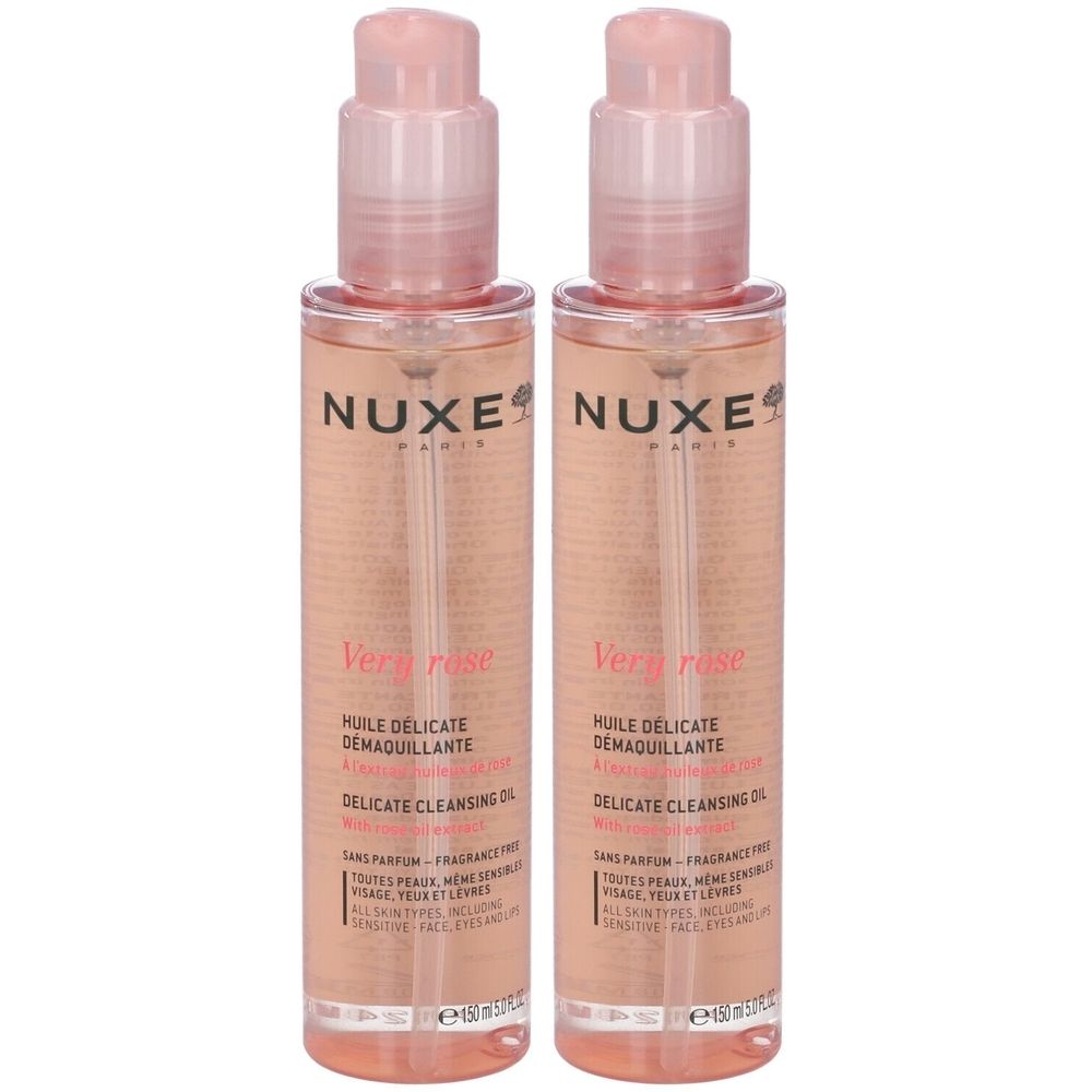 Due flaconi di liquido rosa con vaporizzatore. Scritta: Nuxe, Very Rose, Olio Struccante Delicato. Per tutti i tipi di pelle.
