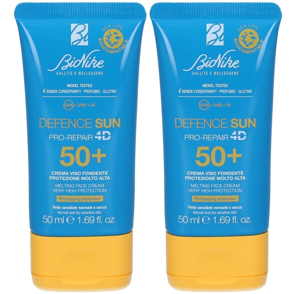 Due tubi blu di crema solare. Scritta: Defence Sun 50+. Marchio: BioNike. Tappo giallo. Testo in italiano.