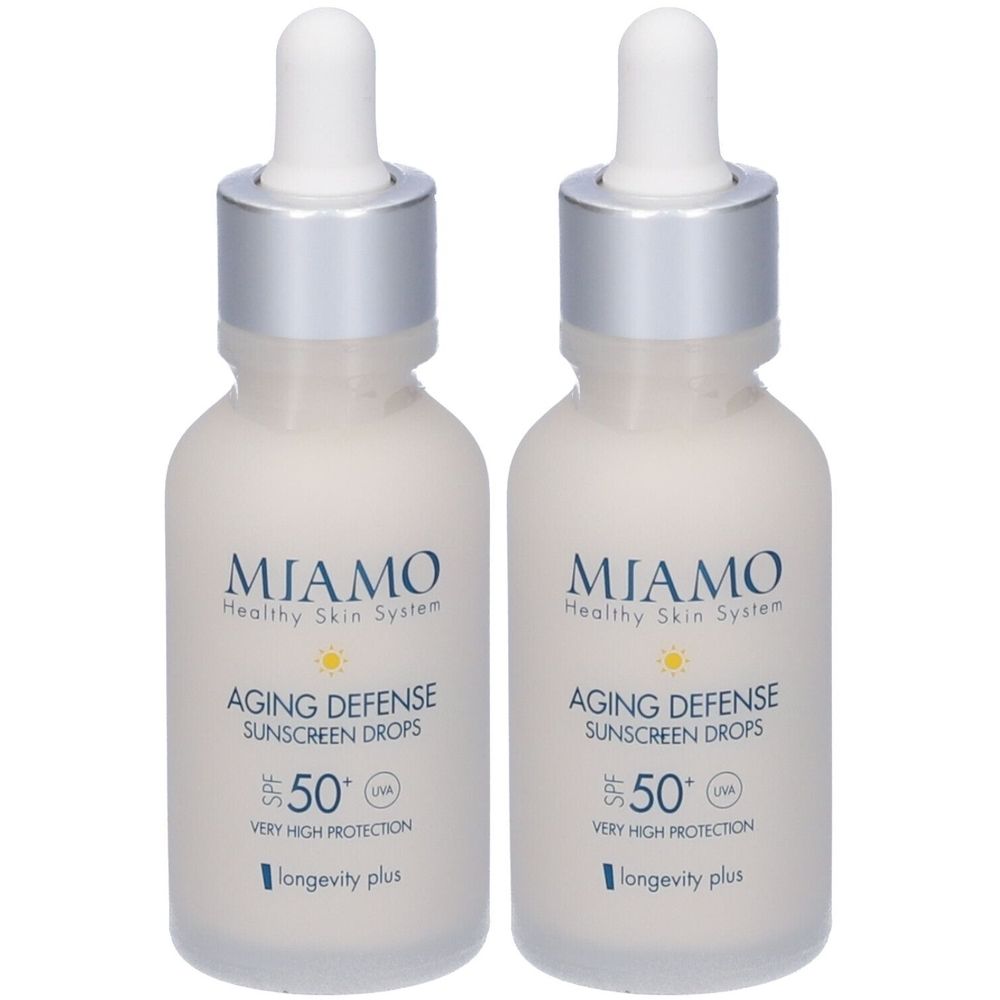 Due flaconi di gocce solari Miamo Aging Defense SPF50+. Flaconi bianchi con tappi argentati e contagocce. Nome del prodotto e fattore SPF.