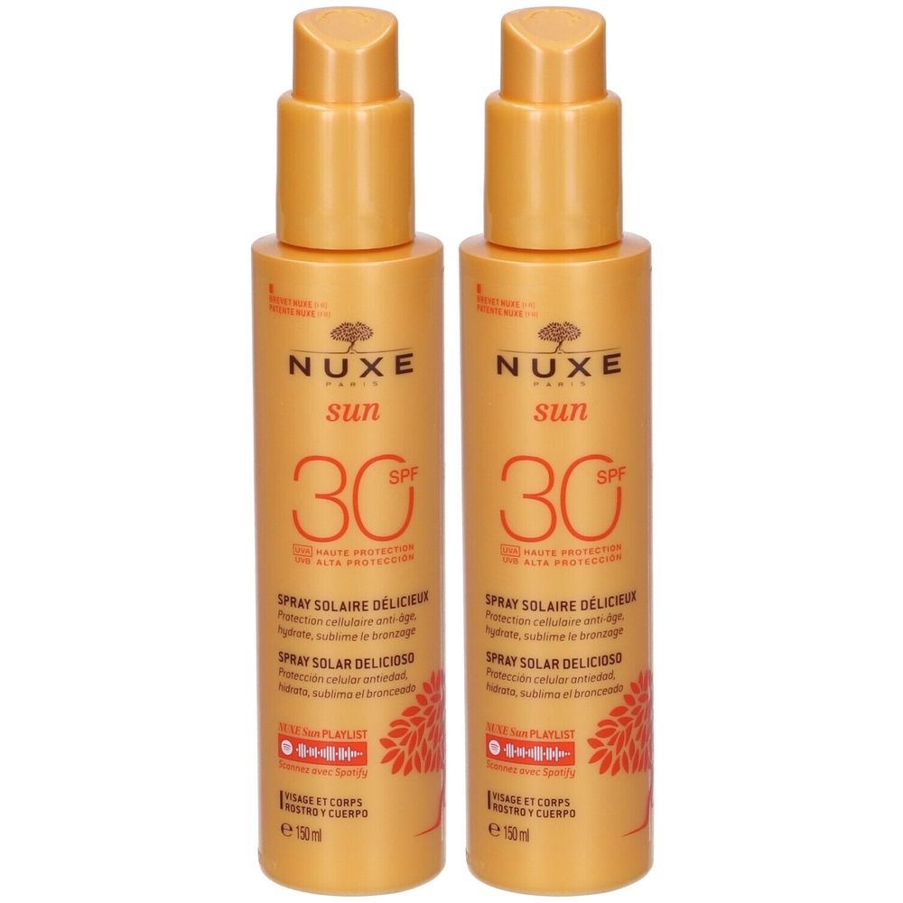 Due spray con flaconi arancioni. Scritta: Nuxe Sun, SPF 30. Spray Solaire Delizioso. Viso e corpo.