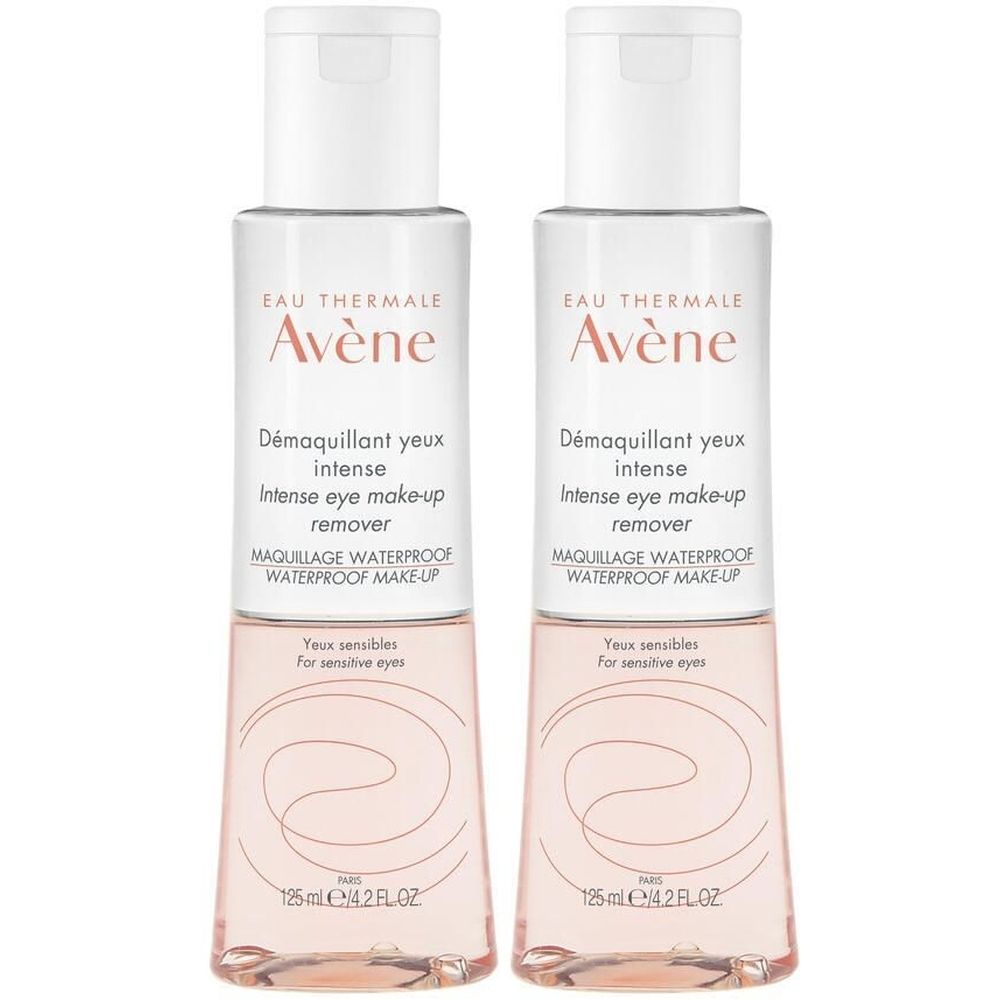 Due flaconi di struccante occhi. Tappo bianco, flacone trasparente con liquido rosa. Scritta: Eau Thermale Avène, Démaquillant yeux intense.