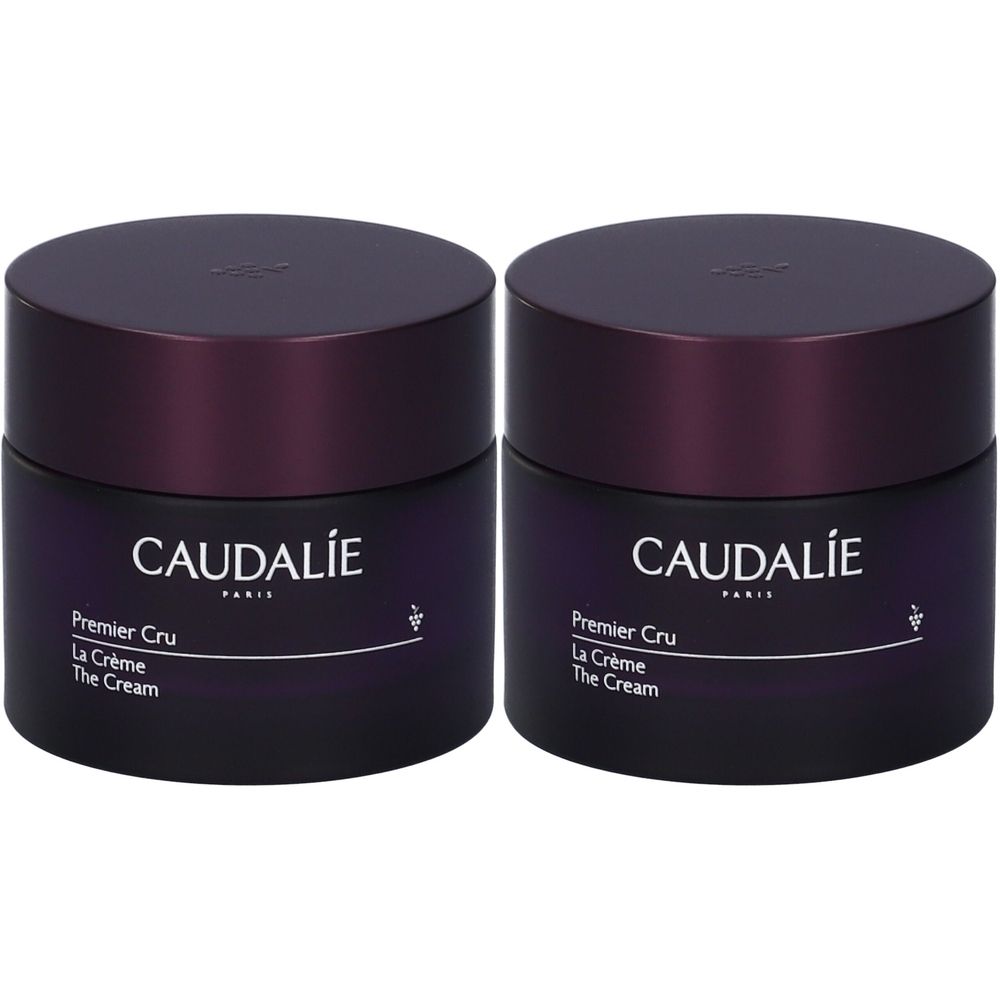 Due vasetti di crema Caudalie Premier Cru. Barattoli viola scuro con coperchi. Scritta Caudalie, Premier Cru, La Crème, The Cream.