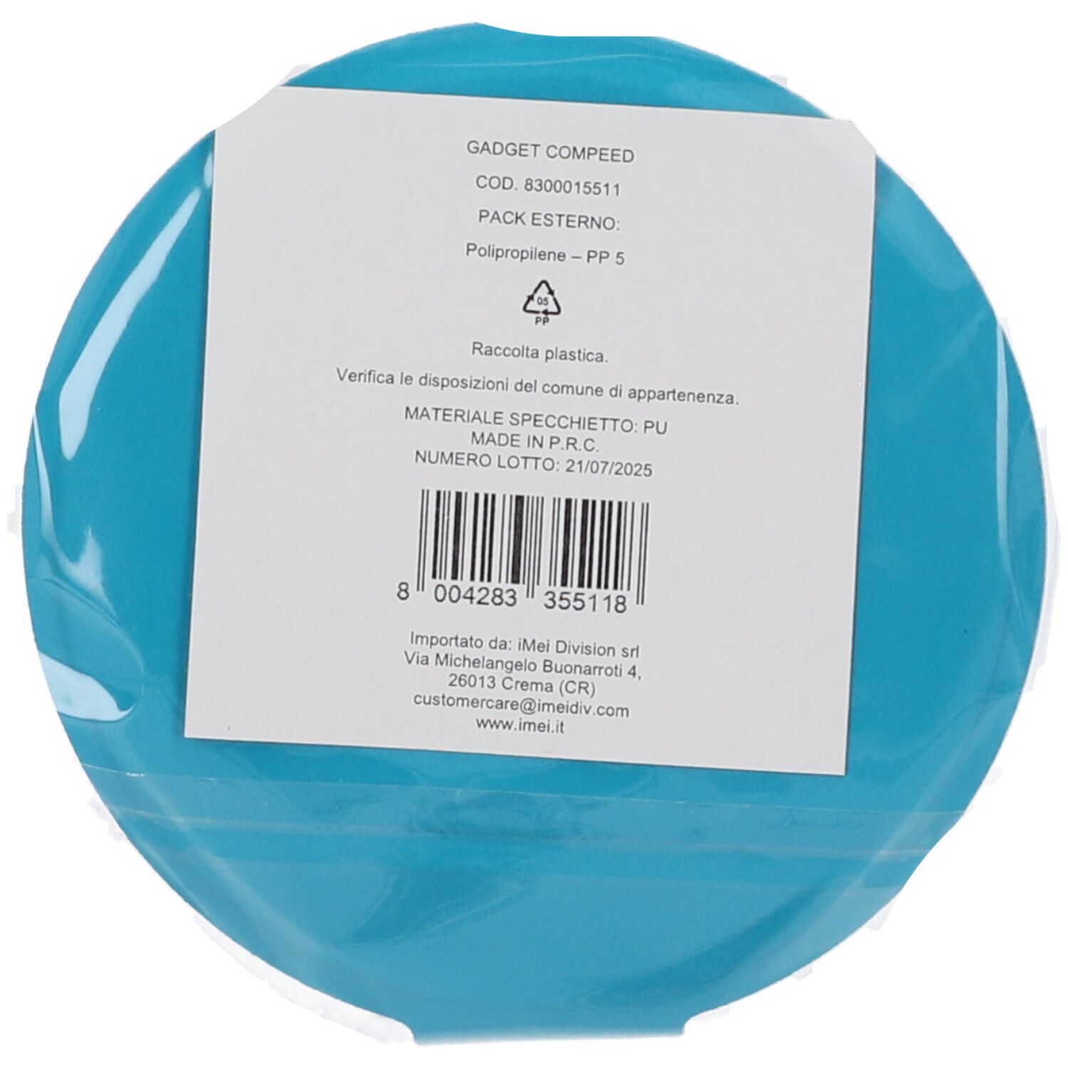 Oggetto rotondo turchese in pellicola. Etichetta bianca. Testo: "GADGET COMPEED".