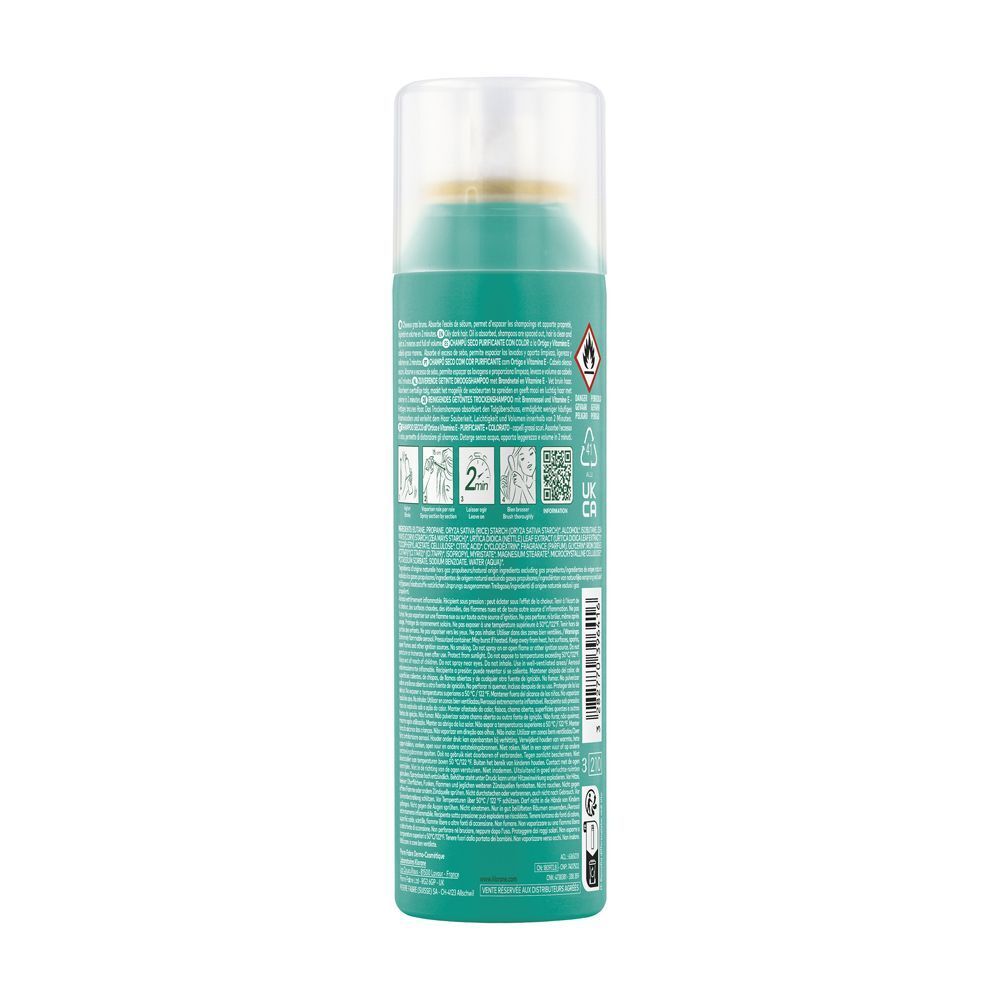 Flacone spray verde. Scritta: Klorane, Shampoo secco all'ortica e Vitamina E. Retro con testo e simboli.