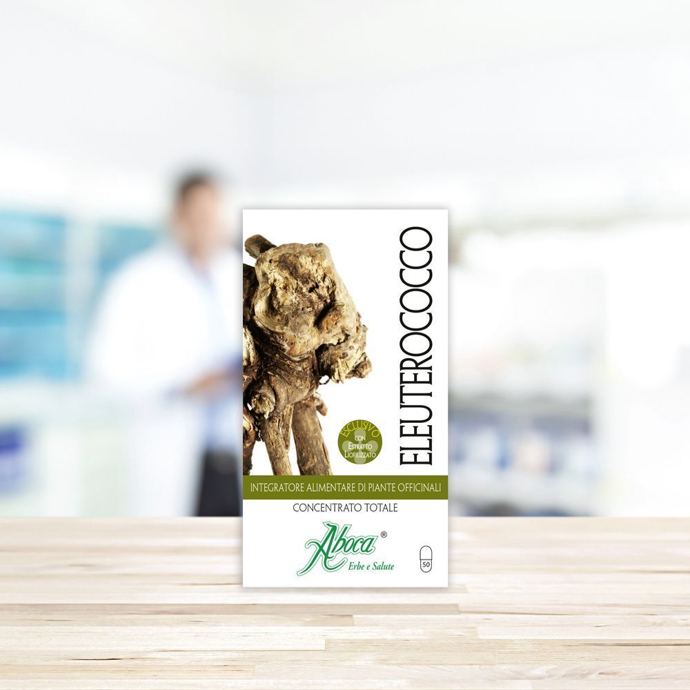 Confezione rettangolare. Scritta: Eleuterococco, logo Aboca, immagine radice. Sfondo: farmacia.