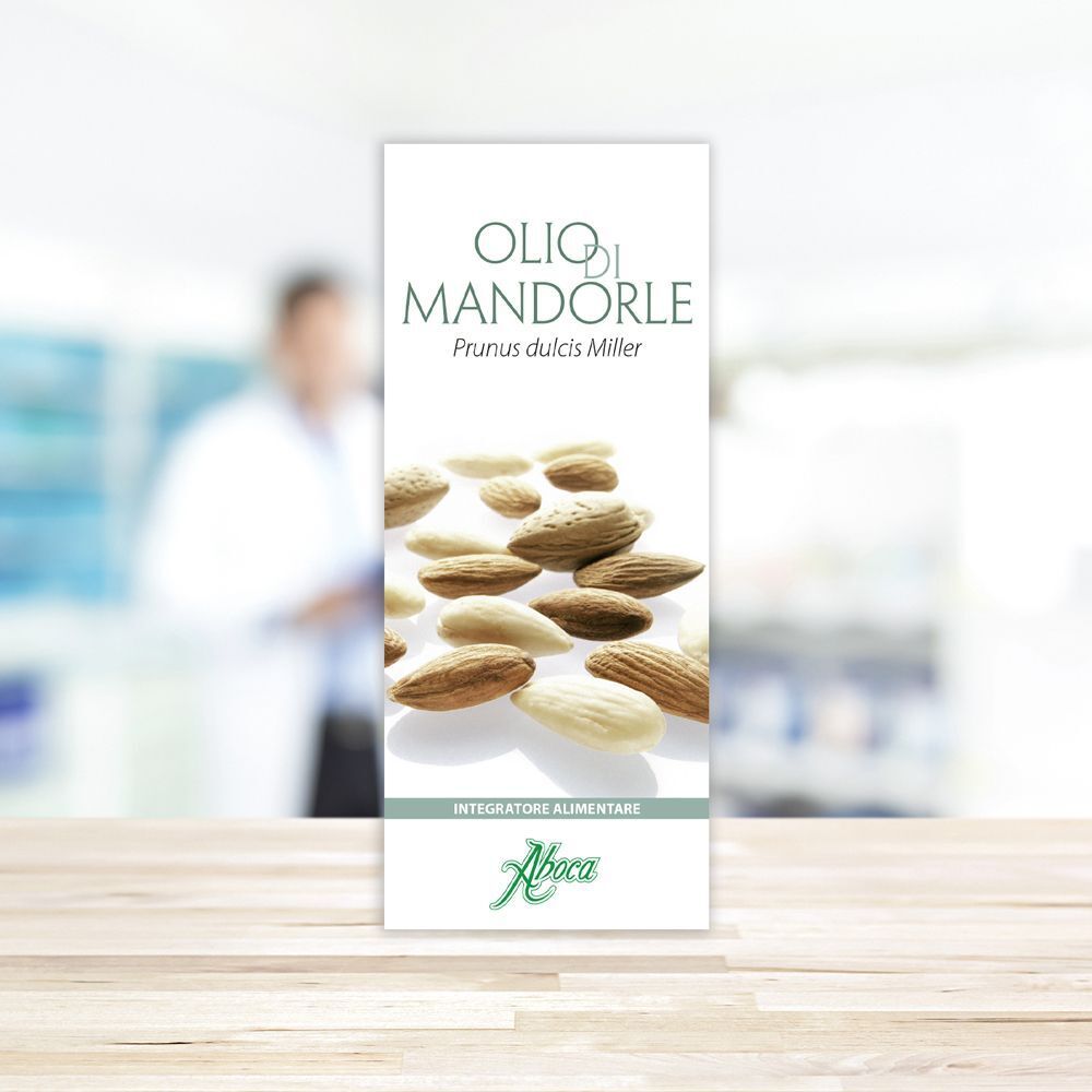 Confezione del prodotto "Olio di Mandorle" con illustrazione di mandorle. Marchio Aboca. Posizionata su un tavolo.
