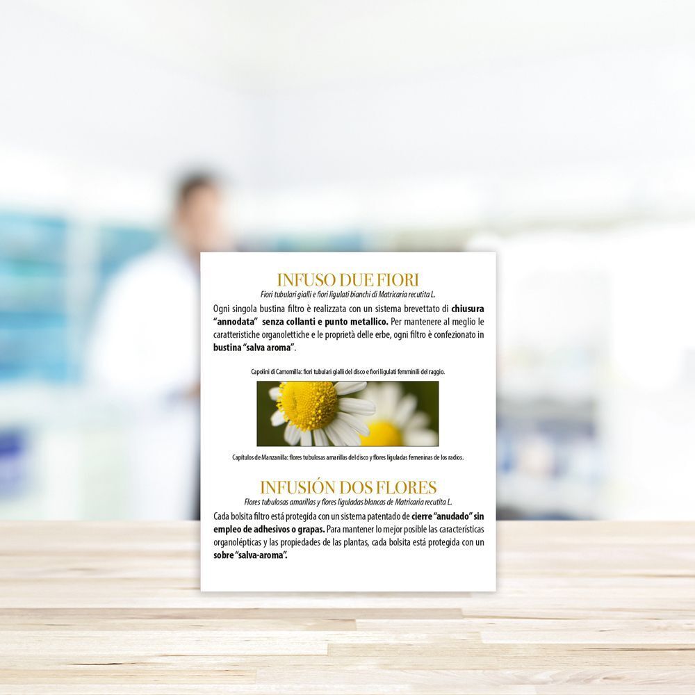 Confezione con testo in italiano e spagnolo. Descrizione delle bustine filtro. Immagine di fiori di camomilla.