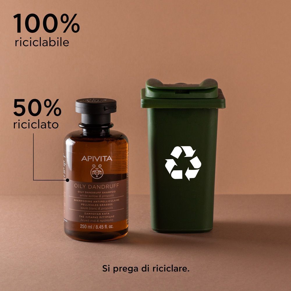Flacone di shampoo APIVITA accanto a un cestino, 100% riciclabile.