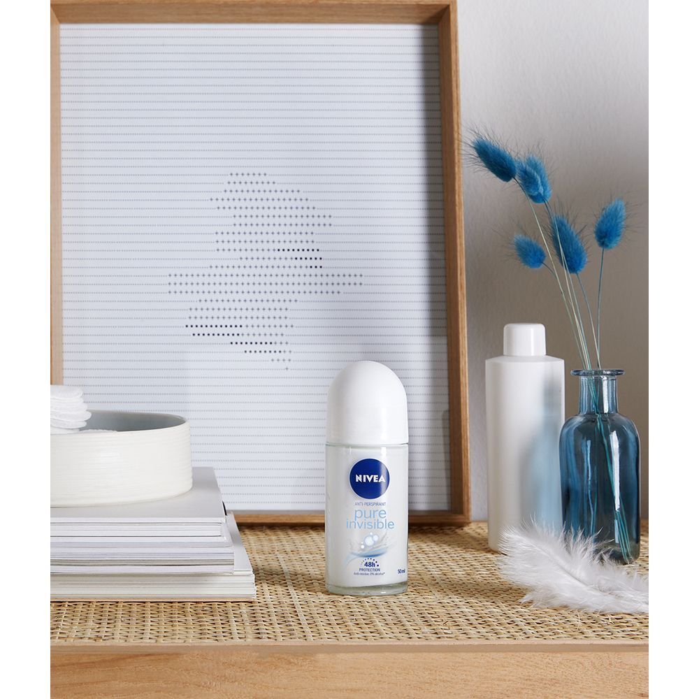 Deodorante roll-on Nivea Pure Invisible su un tavolo con elementi decorativi.