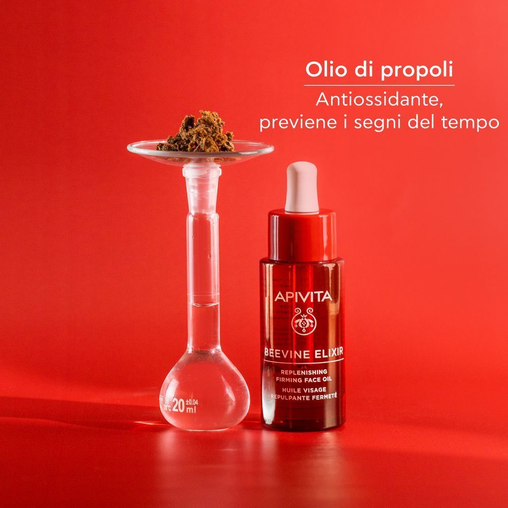 Flacone Olio Viso Apivita Beevine Elixir accanto a un apparecchio da laboratorio con polvere di propoli.