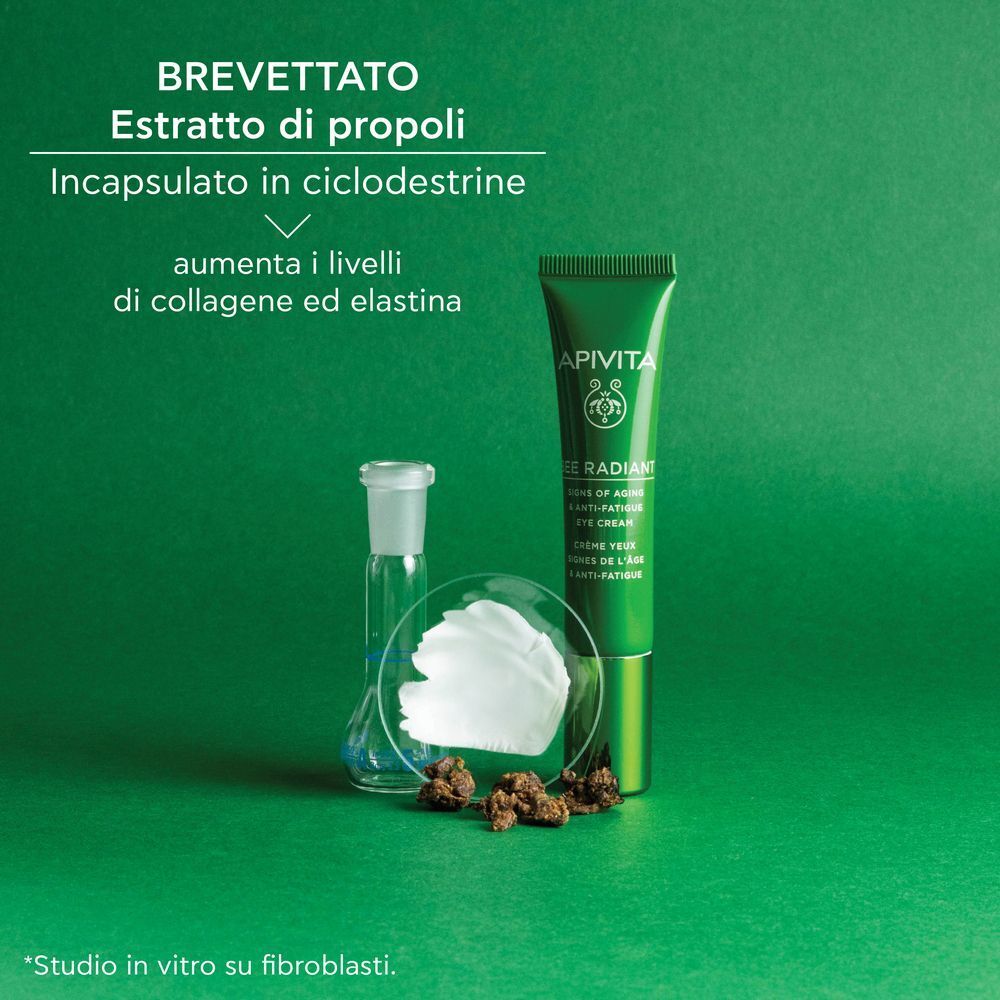 Donna tiene crema contorno occhi APIVITA Bee Radiant. Piccoli punti bianchi sulla pelle.