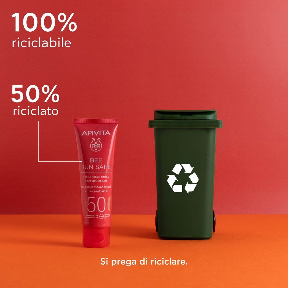 Tubo rosso crema-gel solare SPF 50 accanto a un bidone, 100% riciclabile.