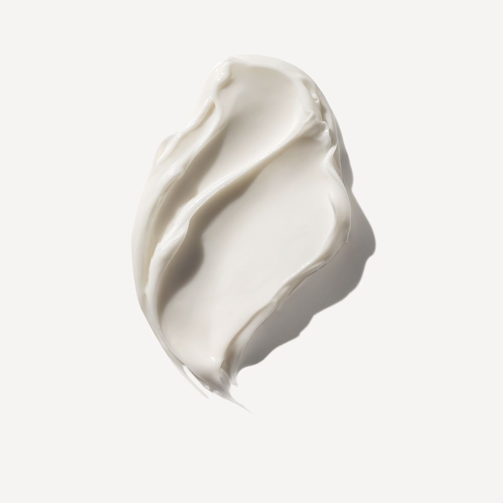 Texture cremosa bianca della Olaplex Rich Hydration Mask su sfondo bianco.