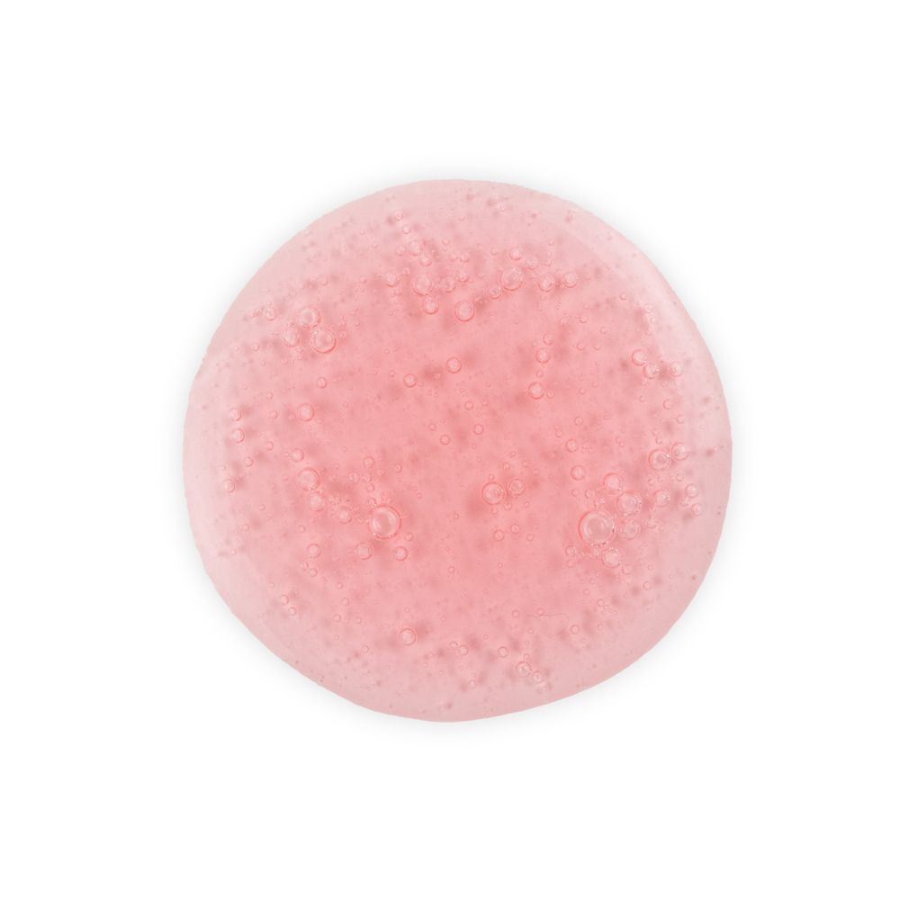Una goccia di texture di shampoo rosa con piccole bollicine d'aria.