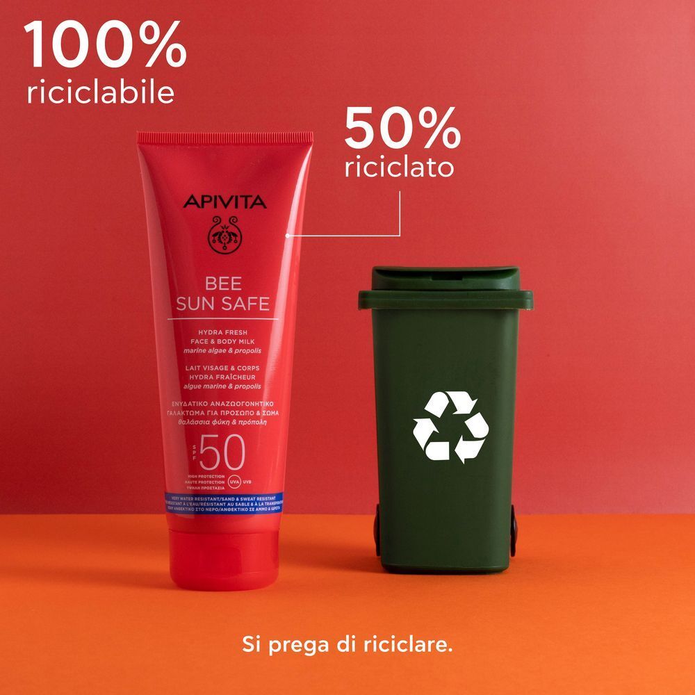 Un tubetto rosso APIVITA Bee Sun Safe SPF50 con testo sul riciclo e materiali riciclati.