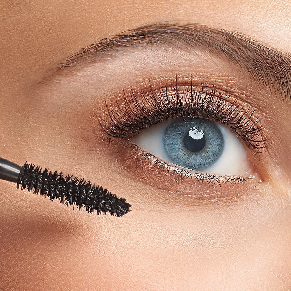 Primo piano di un occhio blu truccato con mascara KORFF Intensity Volume.