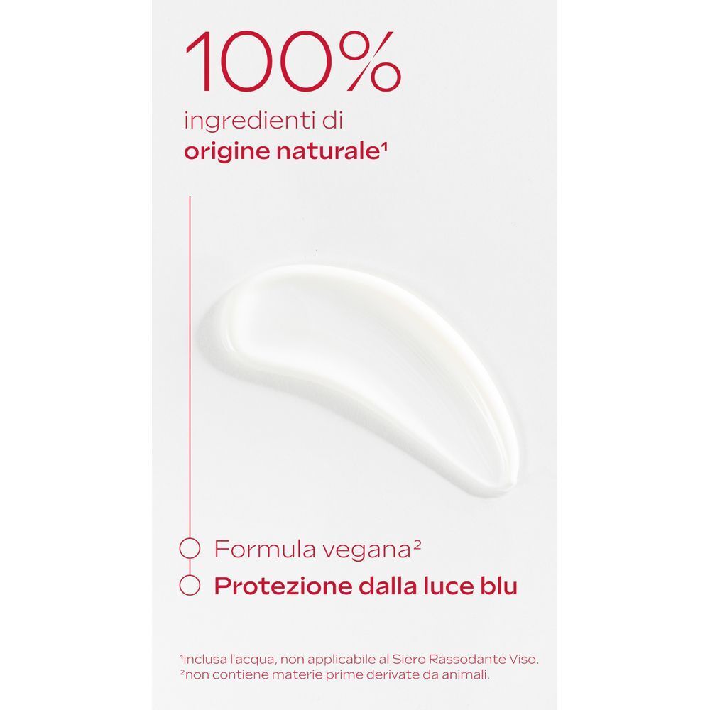 Traccia di crema bianca su sfondo bianco. "100% ingredienti di origine naturale", "Formula vegana" e "Protezione luce blu" indicati.
