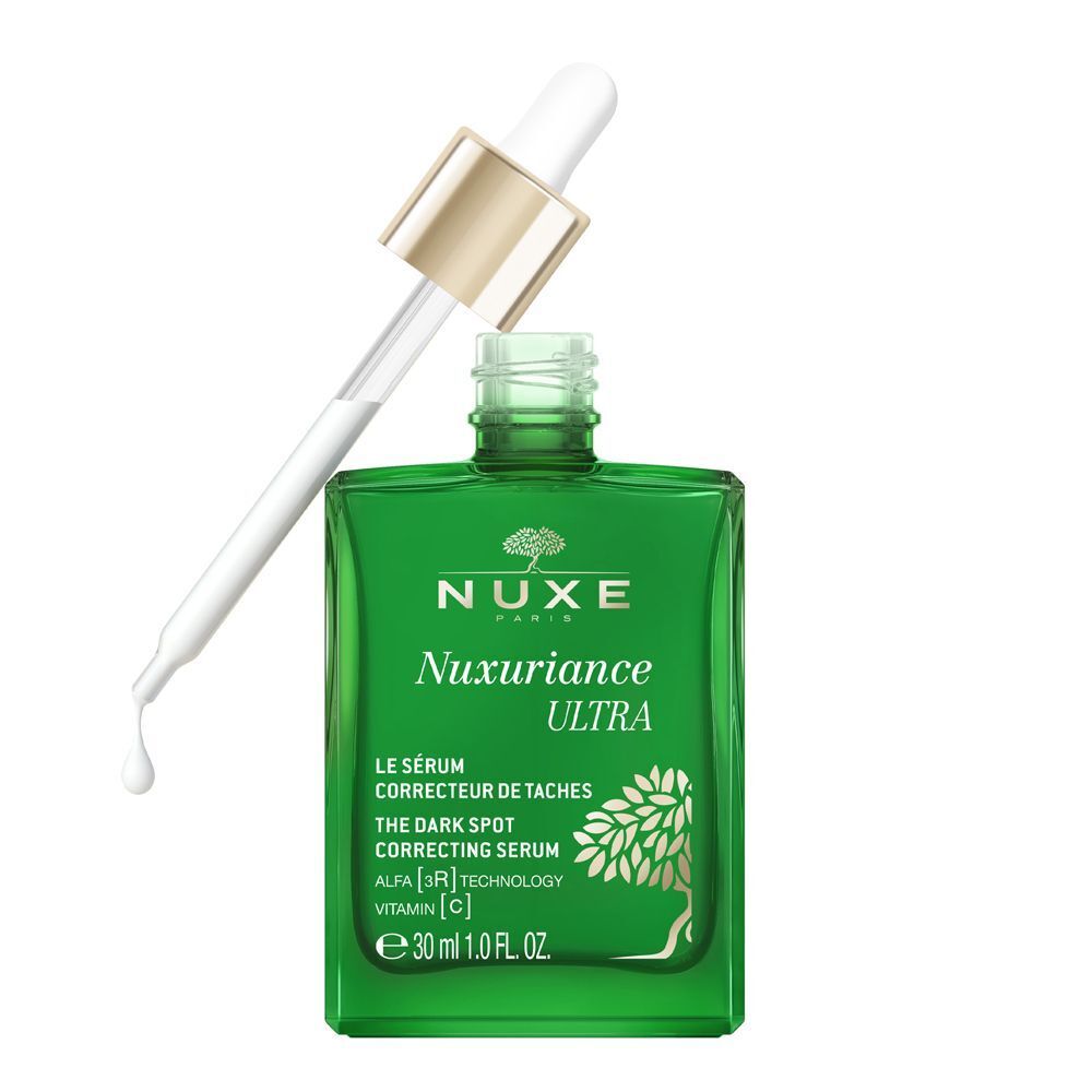Flacone in vetro verde Nuxe Nuxuriance Ultra Siero con contagocce, una goccia cade.
