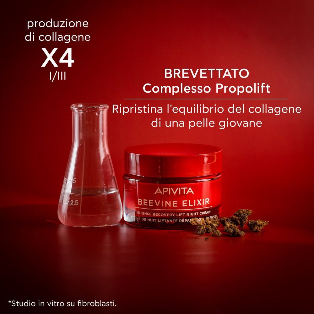 Vasetto Apivita Beevine Elixir accanto a un pallone da laboratorio e uva.