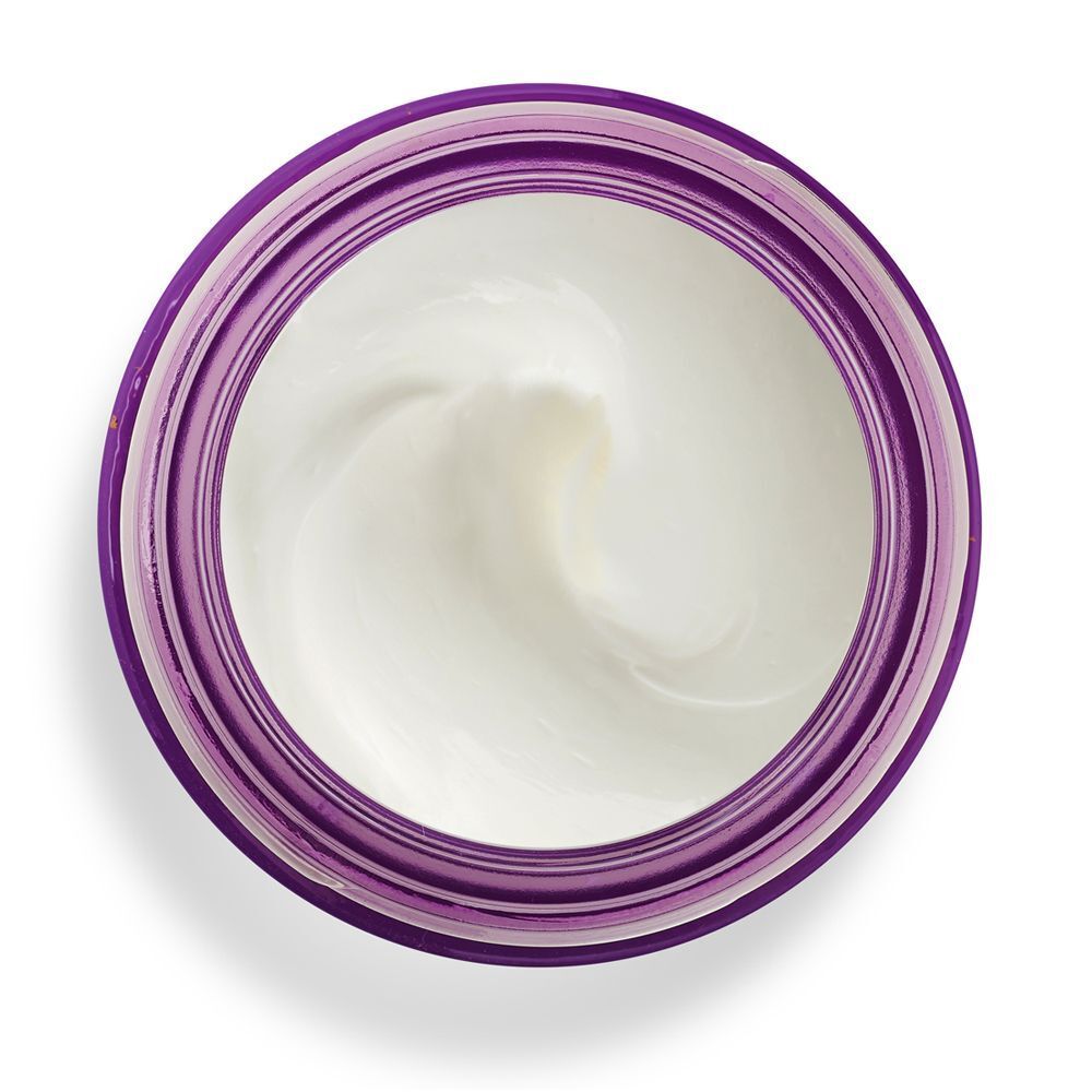 Vista dall'alto di un barattolo aperto di crema viso KORFF Lifting con crema bianca.