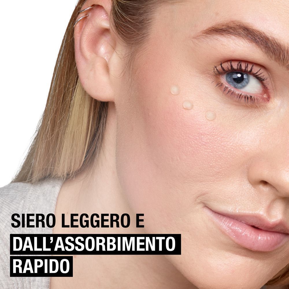 Primo piano di un viso con tre gocce di siero. Testo: Siero leggero e a rapido assorbimento.