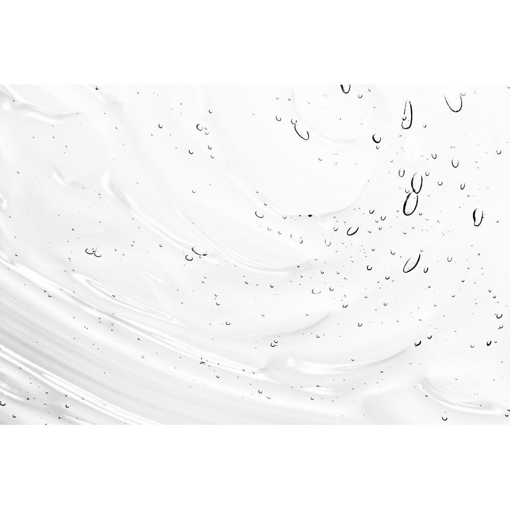 Primo piano della texture del gel detergente AHA con onde e bollicine d'aria.