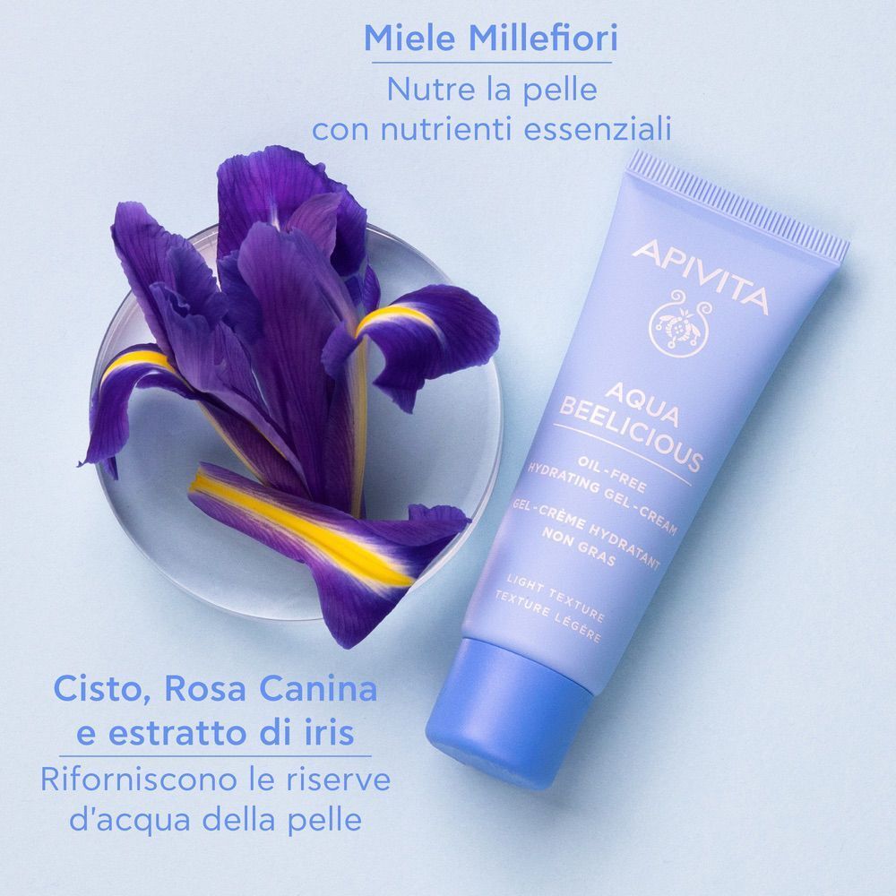 Gel-crema APIVITA Aqua Beelicious vicino a iris viola. Ingredienti: miele, cisto, rosa canina.