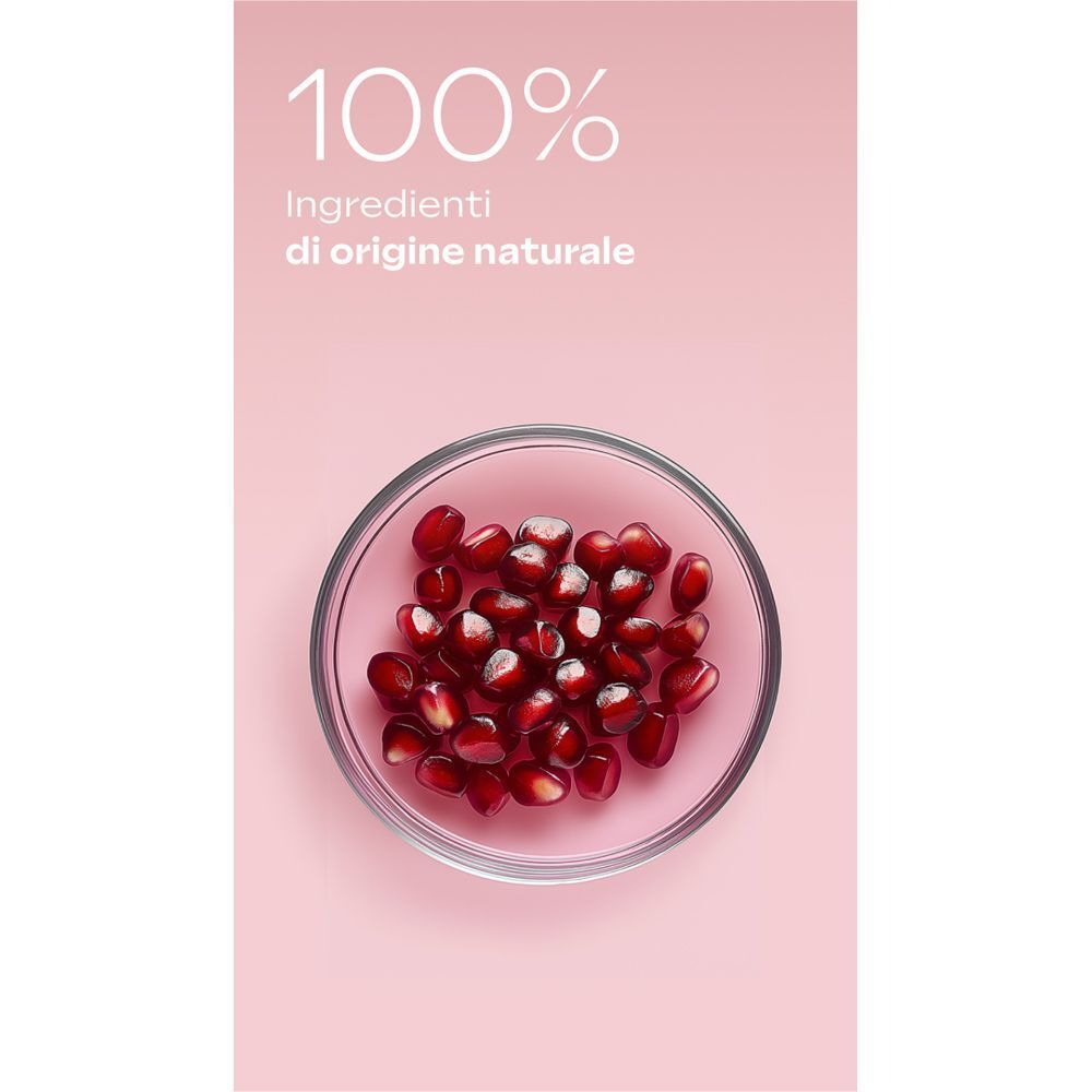 Ciotola di semi di melograno e testo "100% Ingredienti di origine naturale".