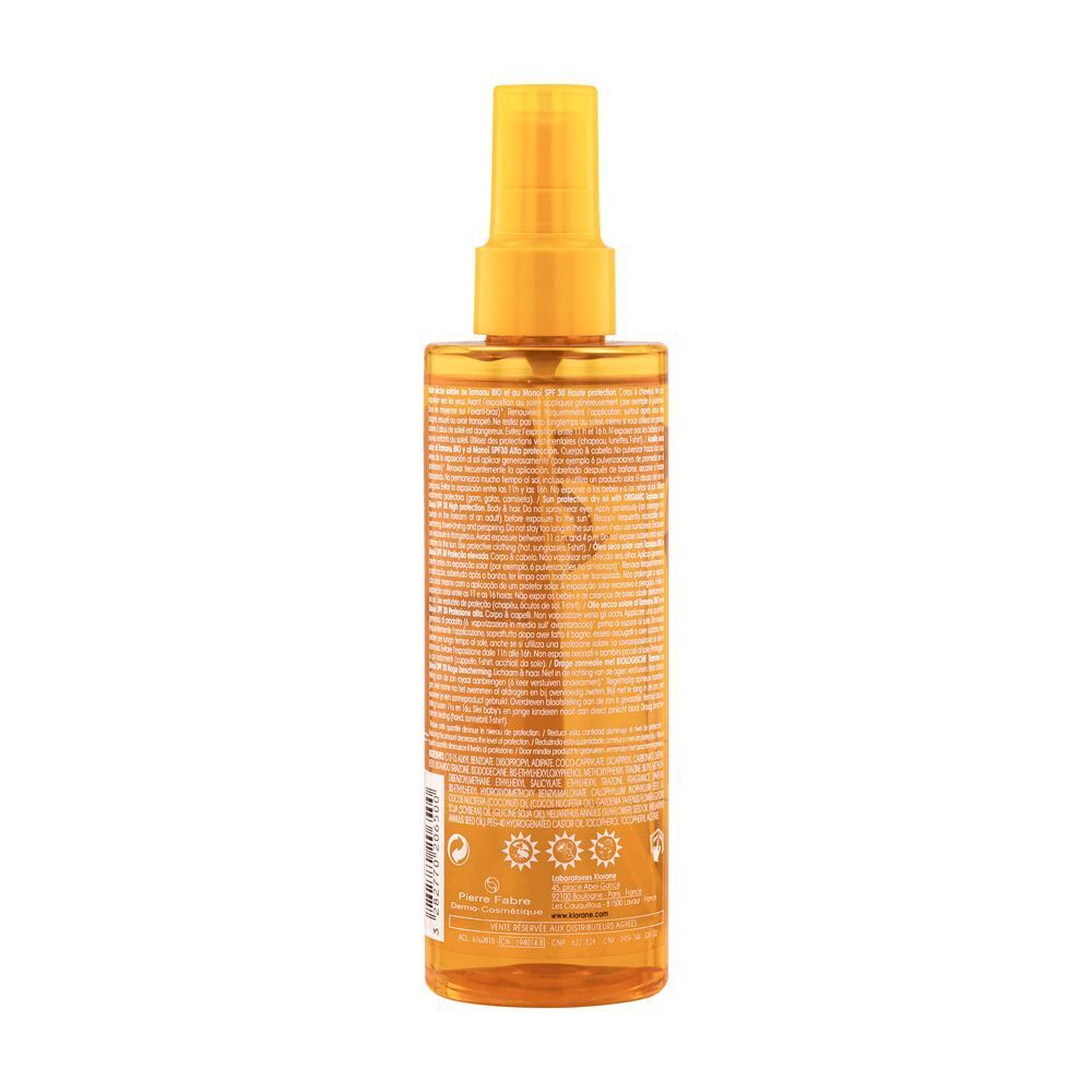 Retro di un flacone spray di olio solare Klorane con informazioni.