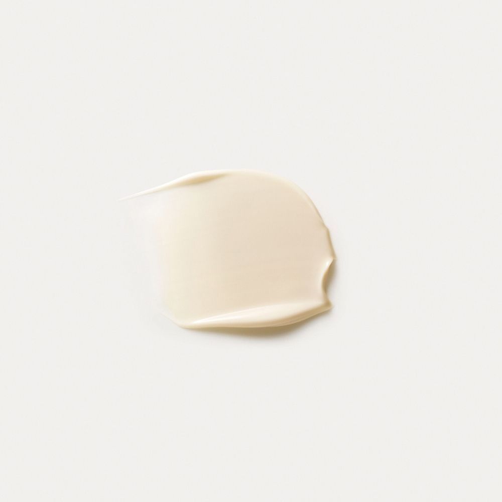 Una striscia di Crema Rigenerante Collo e Décolleté Dr. Hauschka su sfondo bianco.