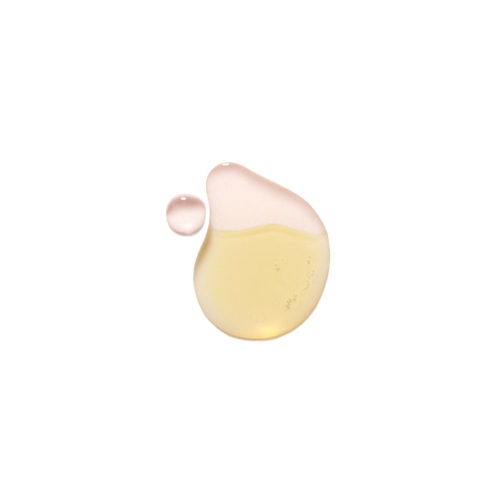 Gocce di liquido giallo e rosa che rappresentano uno struccante per occhi.