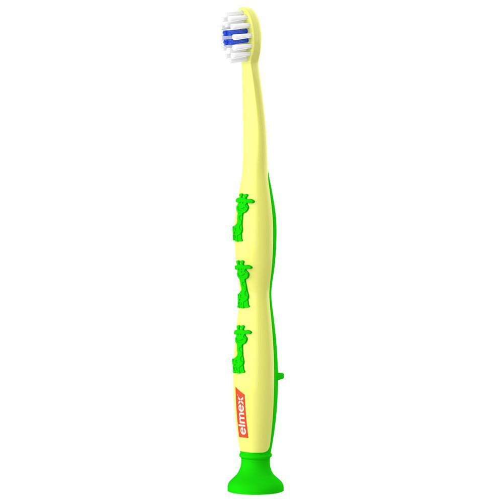 Spazzolino Elmex per bambini (0-3 anni) giallo con giraffe verdi e logo Elmex.
