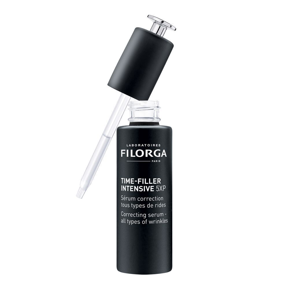 Un flacone nero di siero Filorga Time-Filler Intensive 5XP con tappo a pipetta aperto.