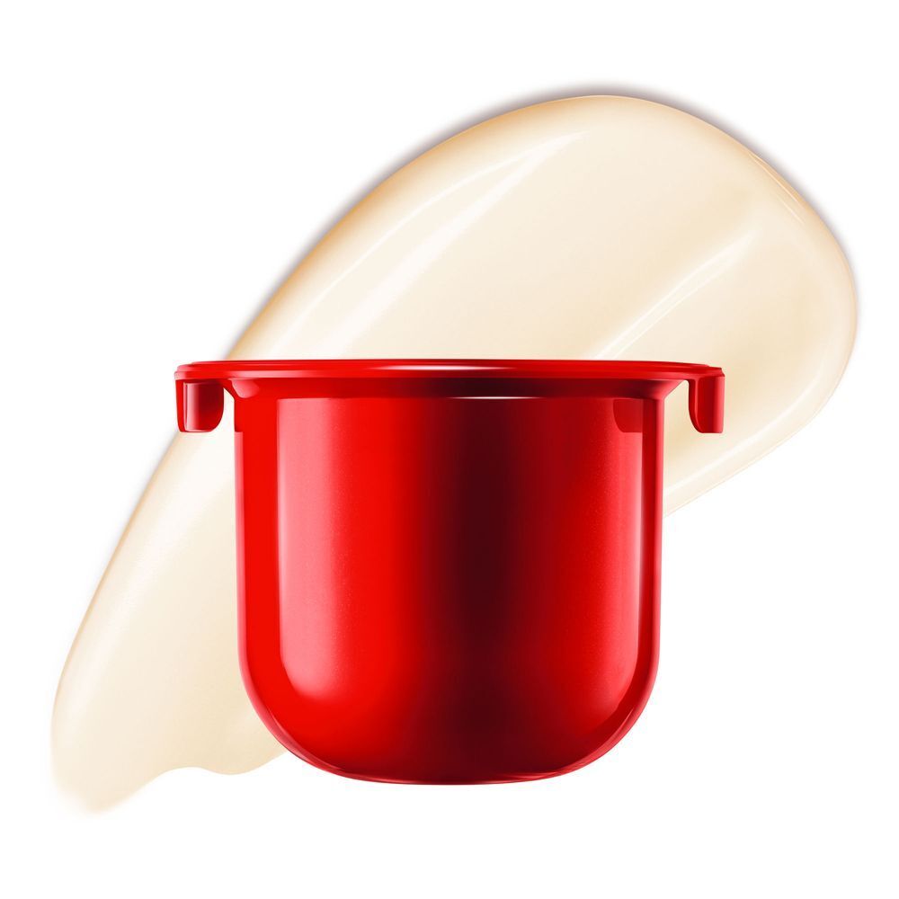 Una capsula ricaricabile rossa per crema viso con un campione di crema.