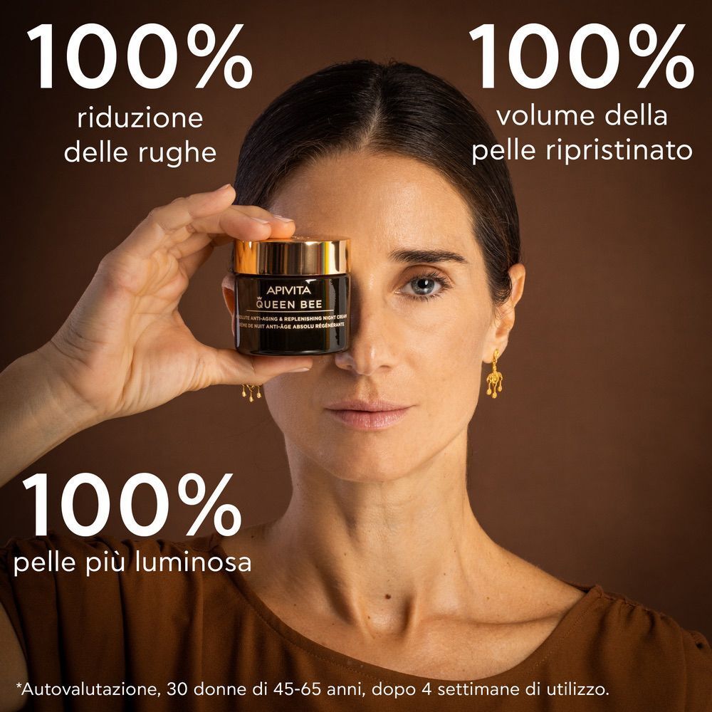 Donna tiene crema notte APIVITA Queen Bee davanti all'occhio. 100% risultati.