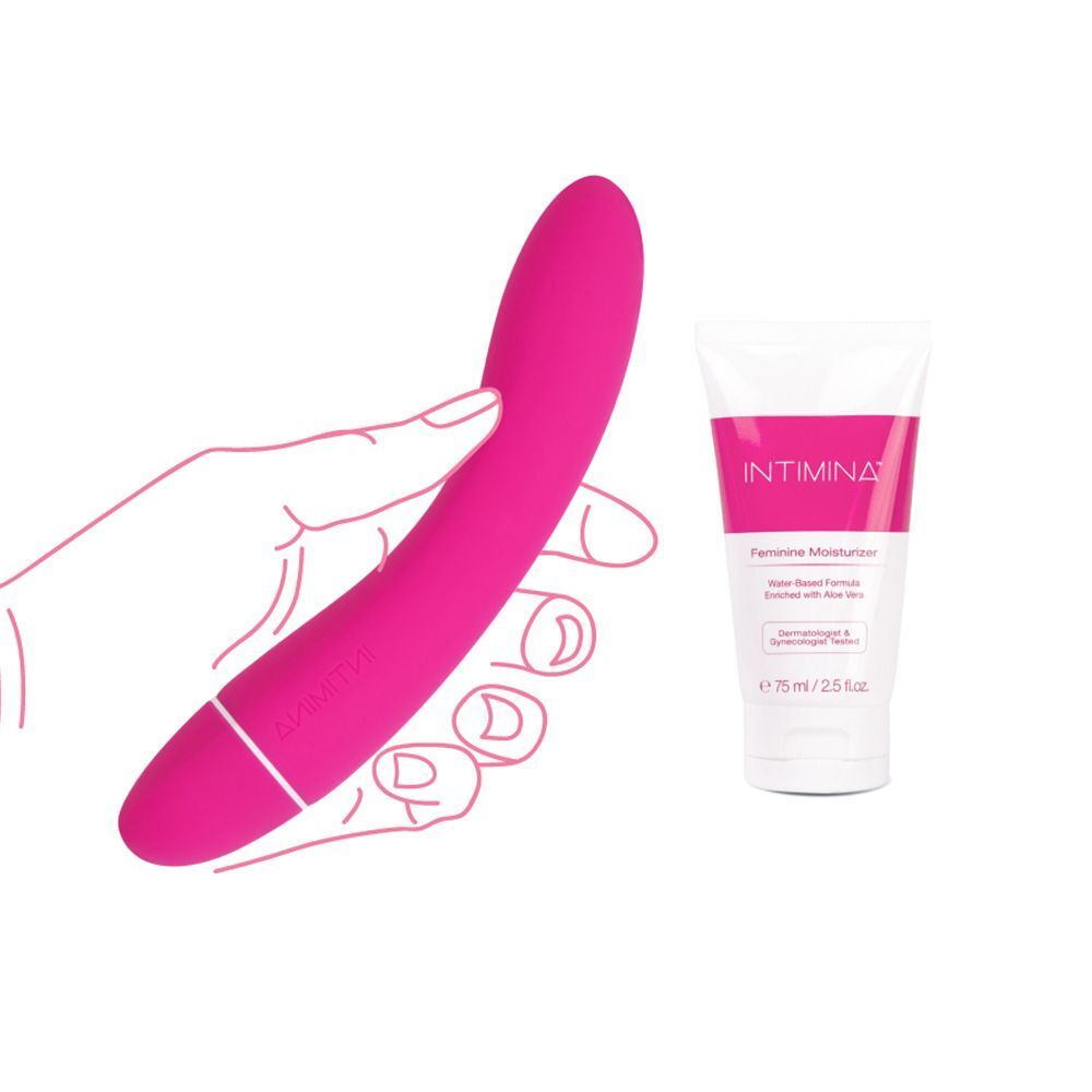 Mano che tiene un vibratore rosa accanto a un tubetto di idratante femminile Intimina.