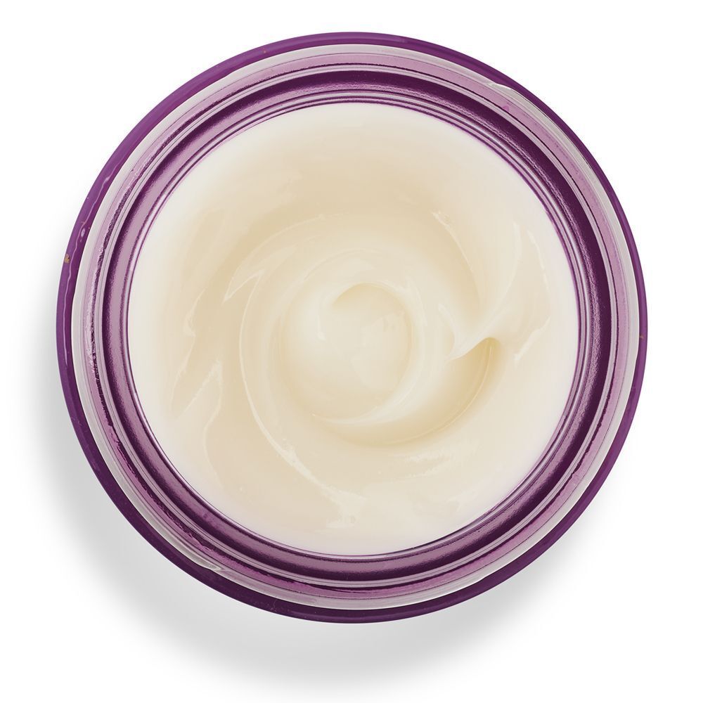 Vista dall'alto di un vasetto aperto di crema viso KORFF Lifting con bordo viola.