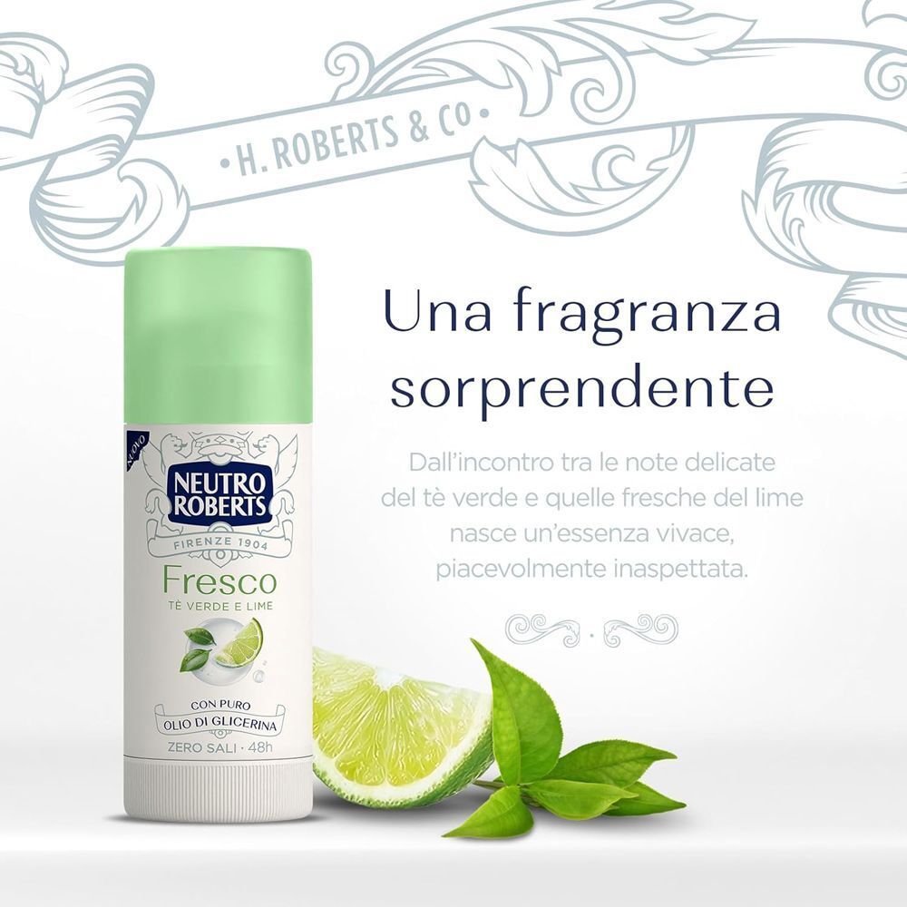 Un deodorante Neutro Roberts Fresco Verde Stick accanto a fette di lime fresche e foglie.