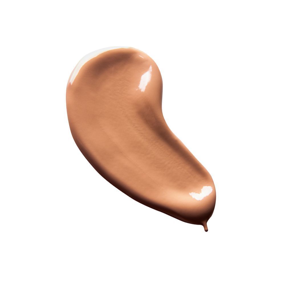 Una goccia di trucco liquido marrone dorato con finitura lucida.