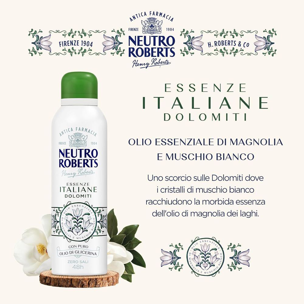 Una bomboletta spray bianca NEUTRO ROBERTS ESSENZE ITALIANE DEODORANTE SPRAY DOLOMITI, accanto a fiori di magnolia.