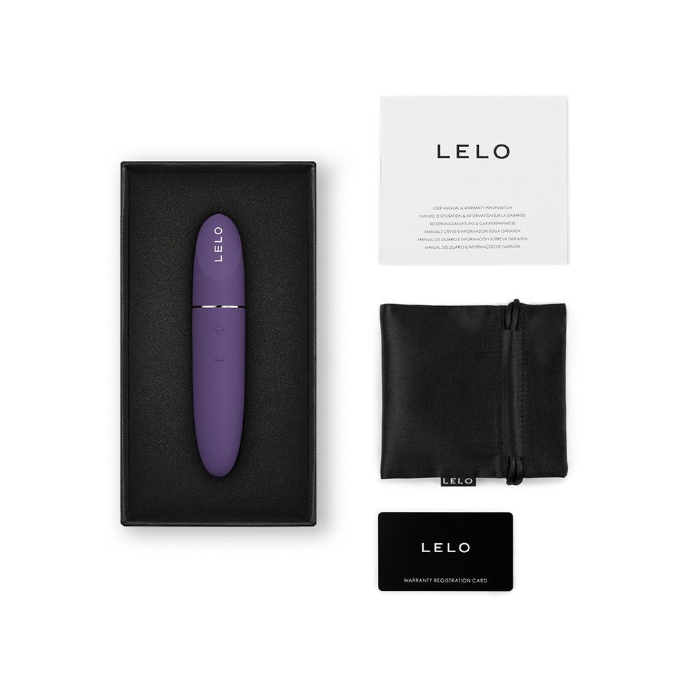 Vibratore viola in scatola nera, con manuale, sacchetto e tessera a lato.