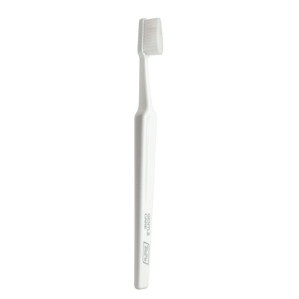 Spazzolino bianco con setole fini e scritta 'GENTLE CARE'.