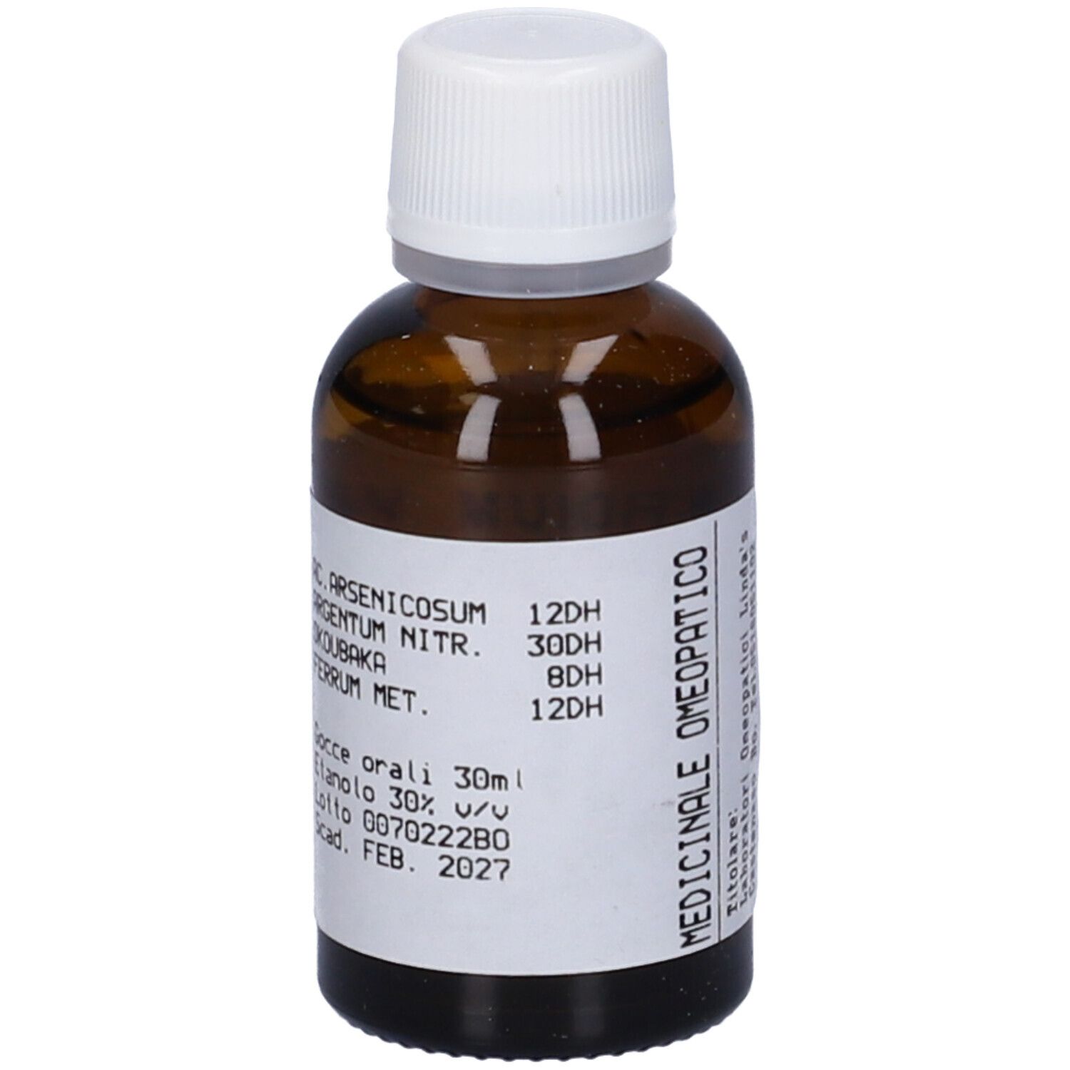 Flacone di vetro marrone con tappo bianco. Etichetta con nome del prodotto e ingredienti. Liquido.