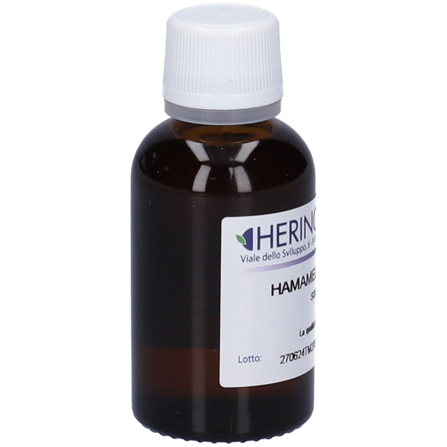 Flacone di vetro marrone con tappo bianco. Etichetta con nome del prodotto e produttore HERING. Testo: HAMAMELIS VIRGINIANA.