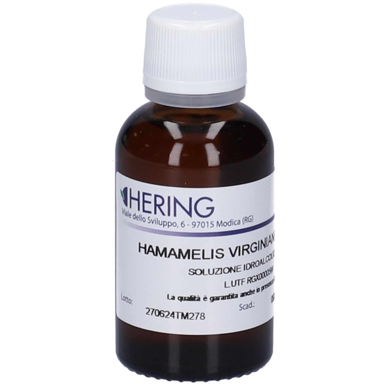 Flacone di vetro marrone con tappo bianco. Etichetta con nome del prodotto e produttore HERING. Testo: HAMAMELIS VIRGINIANA.